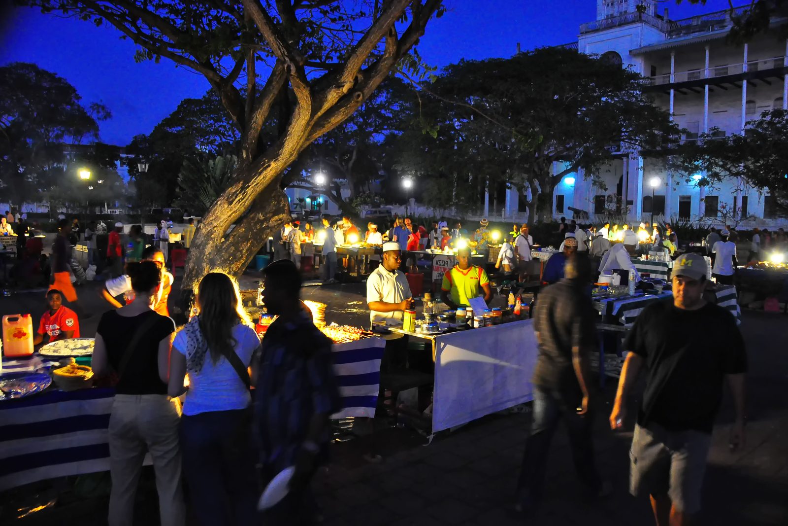Lit food stalls filling Forodhani Gardens after dark
